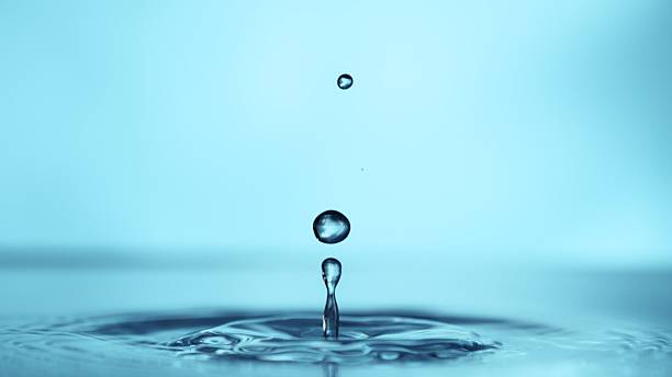 istock Macro Shot of Water Drop Splashing into Liquid. 2206821617