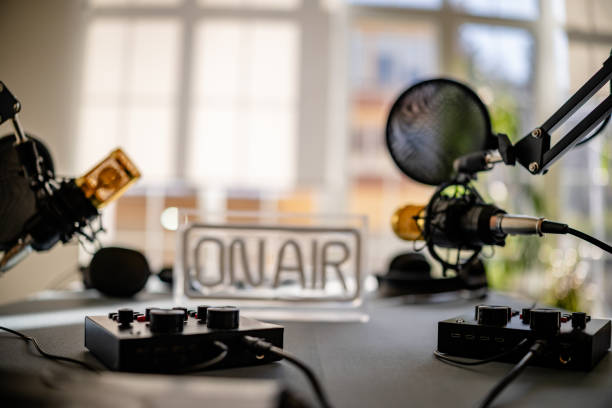 Creative team engages in lively podcast discussion at a well-equipped studio during a vibrant afternoon session