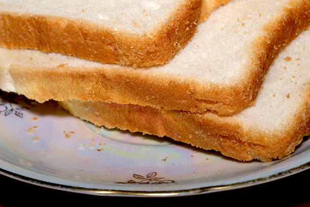 Soft and warm slices of bread rest on a beautifully designed plate.