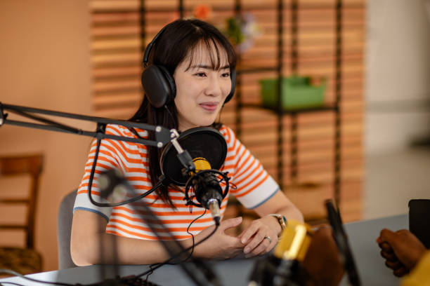 istock Engaging conversation in a lively podcast studio with a young adult host 2206823457