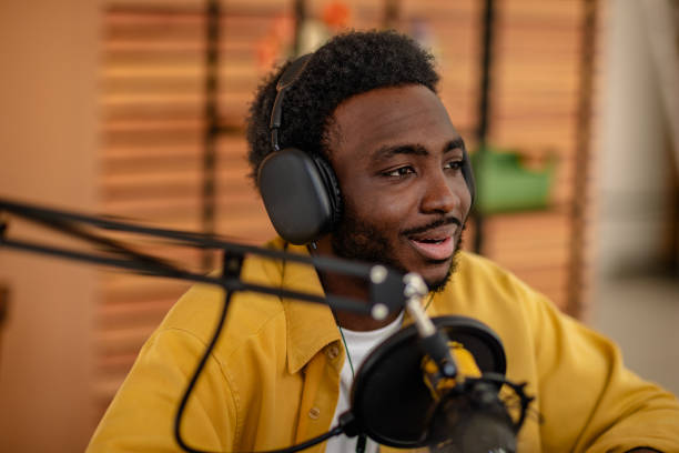 istock Engaging conversation in a podcast studio with headphones and microphone 2206823552