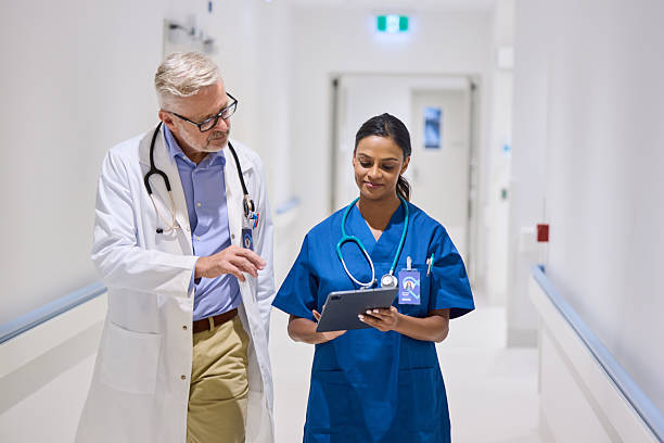 istock Doctor discussing electronic medical reports with nurse 2206823701