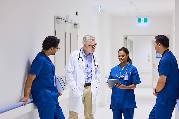 istock Female nurses discussing test results with doctors 2206823709