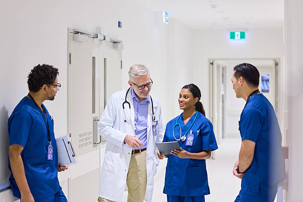 istock Smiling mature doctor looking at electronic medical record 2206823714