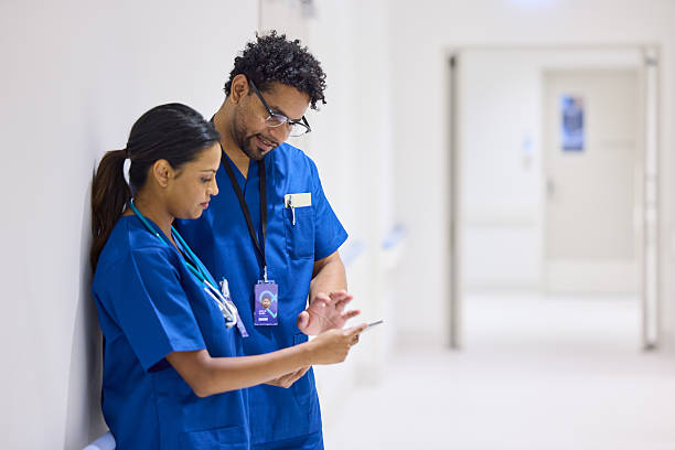 istock Male and female medical experts using digital tablet 2206823748