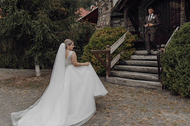 istock A bride is walking down the stairs in her wedding dress 2206824433