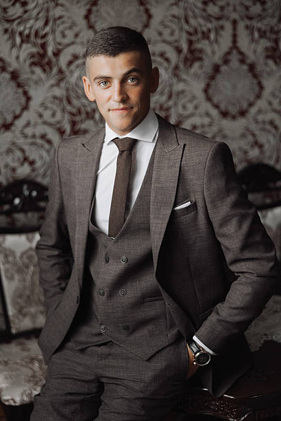 istock A man in a suit and tie is sitting in front of a red wall 2206824565