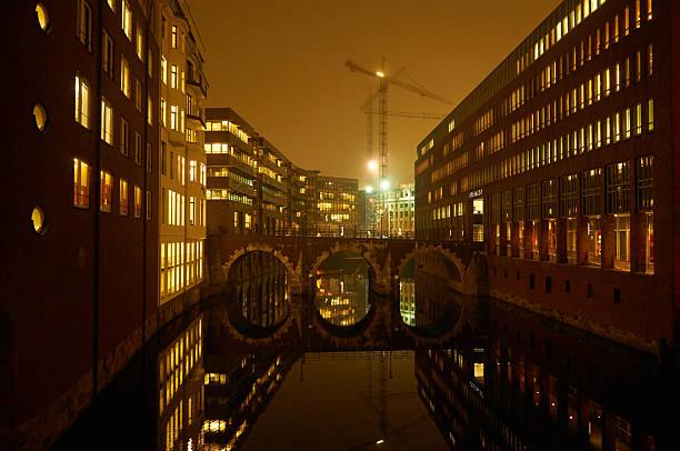 Hamburg, Germany - 12.7.2015 The serene Hamburg canal glows at night with illuminated windows and a charming bridge