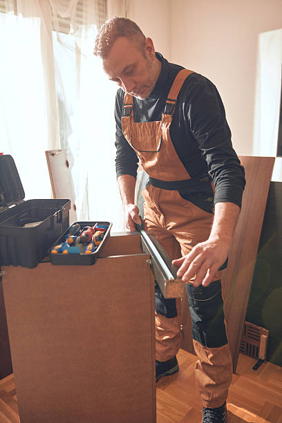 istock Carpenter working and assembling furniture in a new apartment. 2206825509