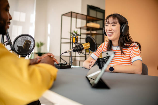 istock Engaging discussion in a modern podcast studio with a cheerful host and guest sharing insights and laughter 2206826197
