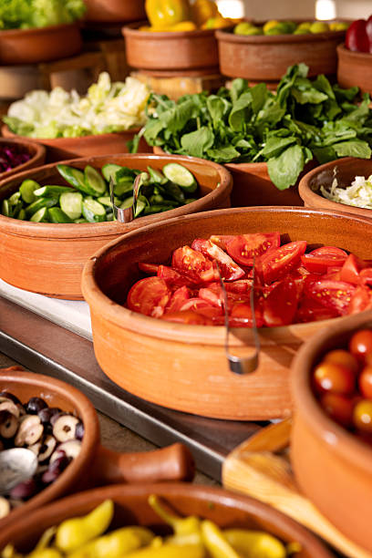 istock Delicious buffet table with Fresh and Vibrant Organic Vegetables in Rustic Clay Bowls and greens, featuring variety of healthy and colorful plant-based dishes for vegetarian or vegan meal 2206827026
