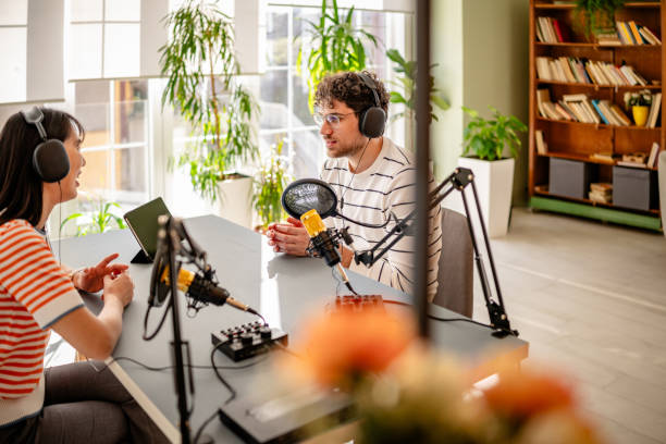 istock Engaging podcast discussion between journalists in a modern recording studio environment 2206827609