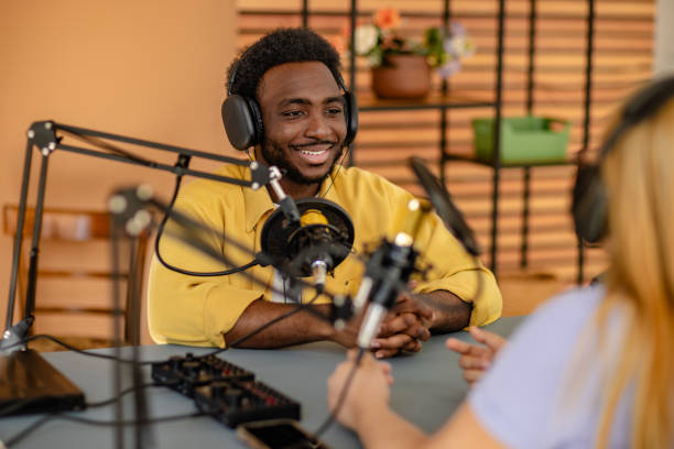 istock Engaging podcast discussion between young adults in a modern studio setting with professional audio equipment 2206828431