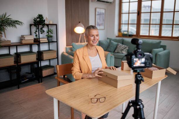 istock Excited Vlogger Films Unboxing in Cozy Home Studio 2206828659