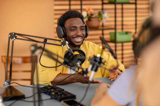 istock Engaging podcast discussion with a cheerful host and a guest in a vibrant studio setting 2206829225