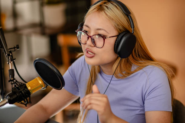 istock Engaging podcast discussion with a young female host in a vibrant studio setting 2206829459