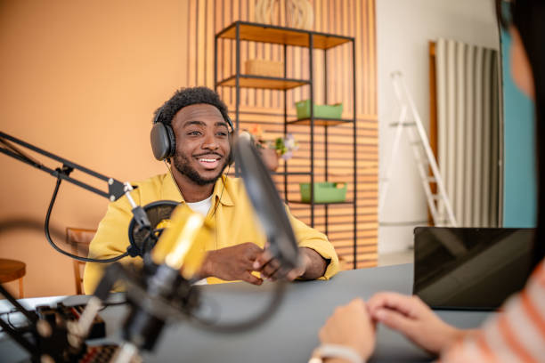 istock Engaging podcast recording session featuring young adults in a creative studio environment 2206830114