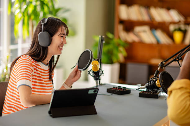 istock Joyful conversation in a modern podcast studio with young professionals engaging in an interview 2206832017