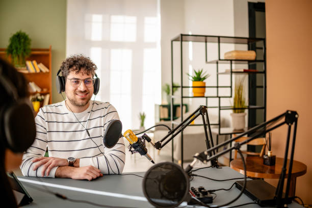 istock Podcast hosts engage in lively discussion with sound equipment in a vibrant studio environment during a recording session 2206833647