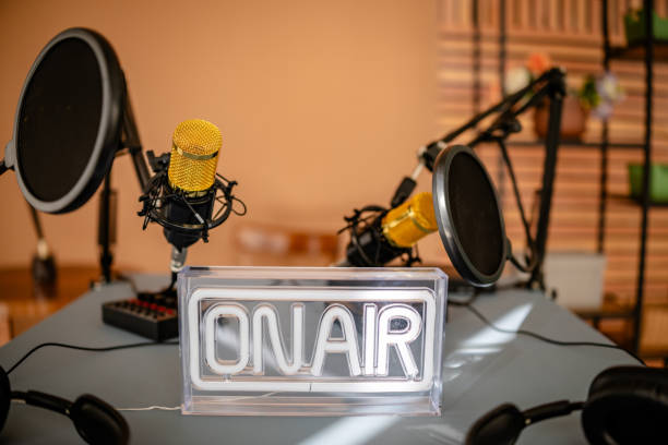 istock Podcast recording setup featuring microphones and an 'on air' sign in a creative workspace for a live broadcast 2206834679