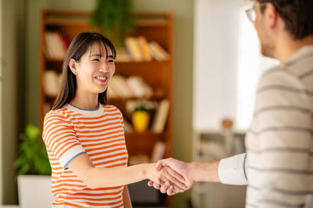 istock Two professionals engage in a cheerful handshake during a podcast interview at a modern studio workspace 2206836728