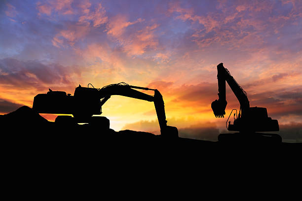 istock Crawler excavators silhouette are digging the soil in the construction site. 2206840257