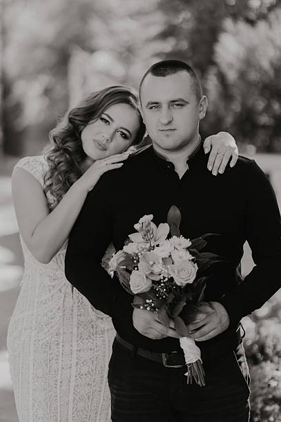istock A man and a woman are posing for a picture 2206841095