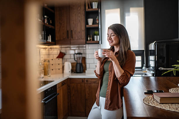 istock Woman relaxing in kitchen, enjoying a cup of coffee 2206843021