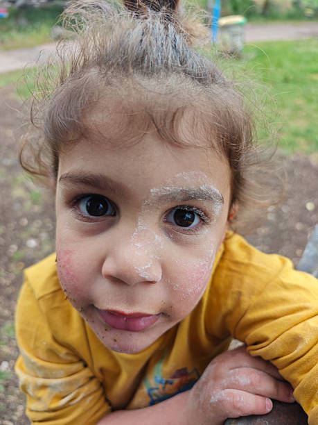 istock Curious Boy with Flour on His Face Looking at Camera. 2206845311