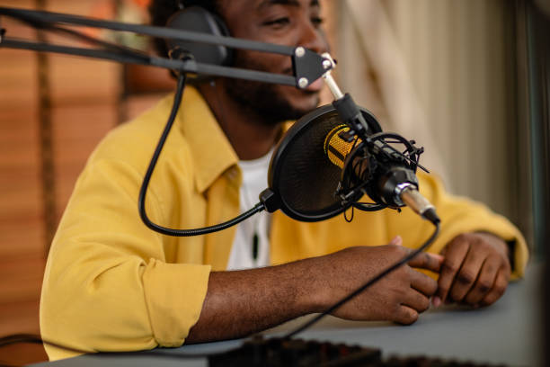 istock Podcast host engages in lively discussion with guest in a professional studio environment focusing on audio production 2206845914