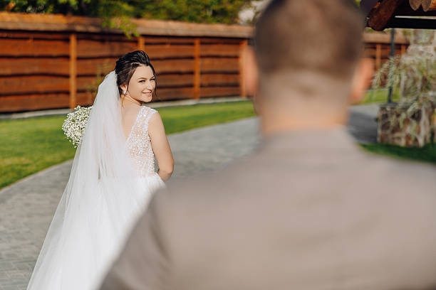 istock A bride is walking down a path with a bouquet of flowers in her hand 2206846930