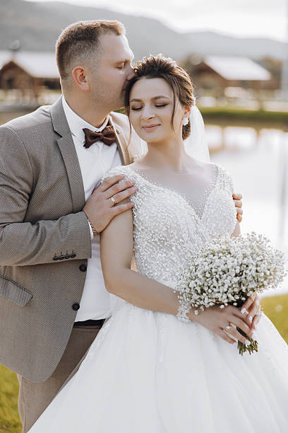 istock A bride and groom are posing for a picture 2206847442
