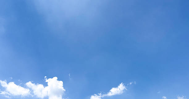 istock Single, fluffy white cloud stands out against a bright blue sky. Beautiful clear sky daytime photos for website banners and so on. 2206849299