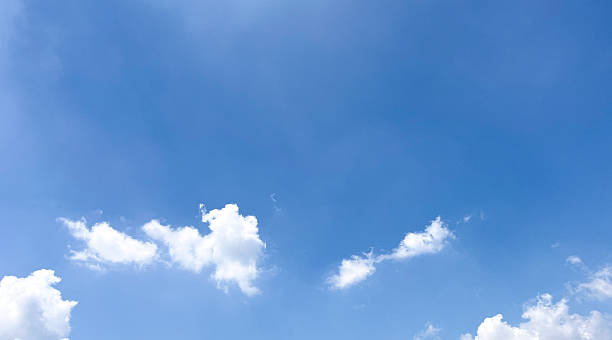 istock View of a blue sky with white fluffy clouds, creating a peaceful and serene atmosphere. Beautiful clear sky daytime photos for website banners and so on. 2206849390