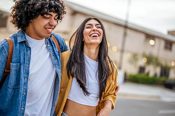 istock Joyful Friends Walking Outdoors and Sharing a Cheerful Moment Together 2206850597