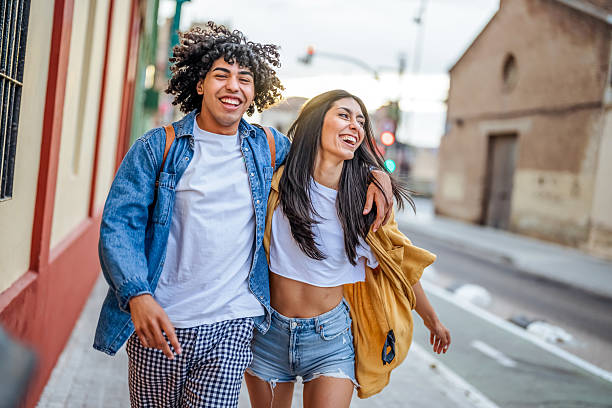 istock Happy Young Couple Walking Together Outdoors in a Bright Urban Setting 2206852102