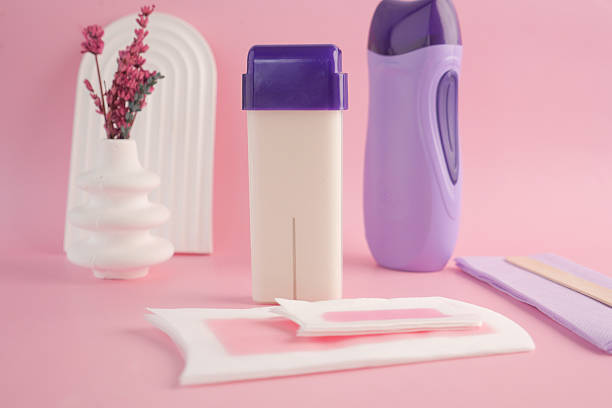 istock Aesthetic Waxing Kit featuring Applicator and Strips set on a Pink Background 2206853214
