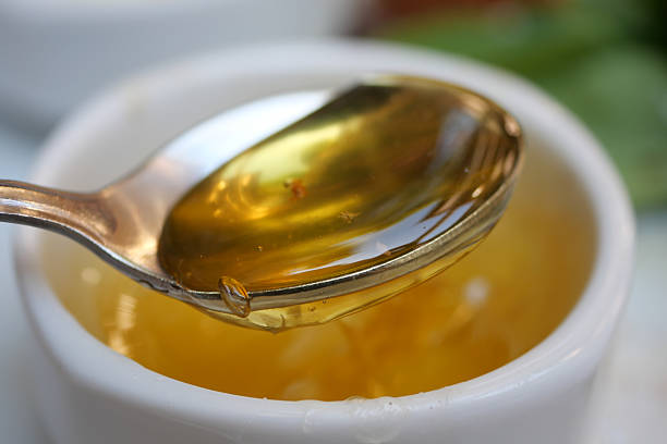 istock A Beautiful Golden Honey Displayed in a Spoon and a Dish for Enjoyment 2206853583