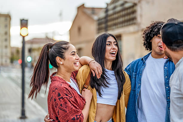 istock Group of Four Friends Laughing Outdoors on a Sunny Day 2206853869