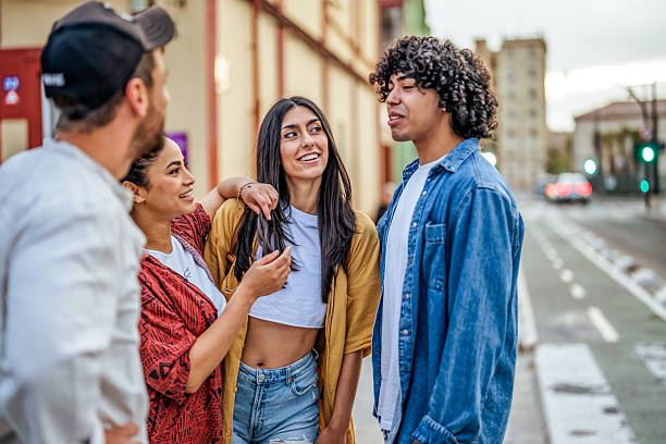 istock Friends Chatting Casually Outdoors on a City Street During Sunset 2206853928