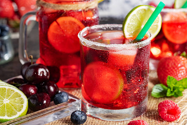 istock Red drink with ice. Raspberry, lime, strawberry, blueberry and mint leaves. Berry mojito in a misted glass. 2206856393