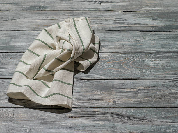 istock Wooden background with linen kitchen towel or textile napkin. 2206856514