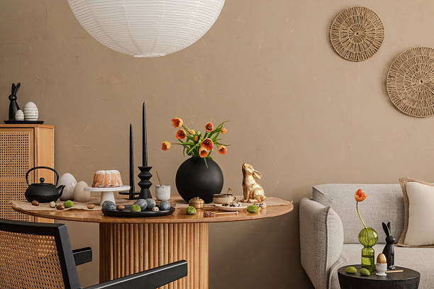 istock A minimalist Easter-inspired interior with a wooden table, black decorative elements, and a golden rabbit figurine. The composition blends Scandinavian and Japandi aesthetics for a sophisticated yet cozy look. 2206858700