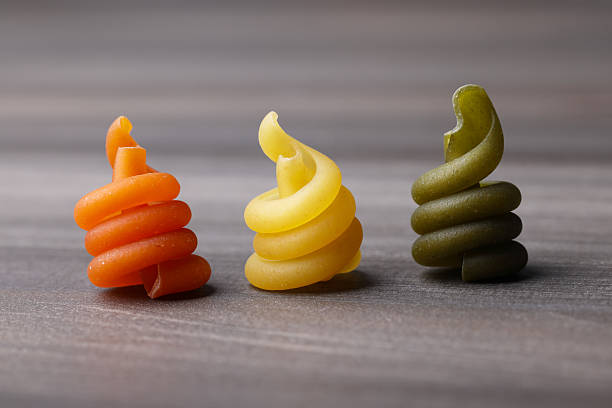 Grocery yellow background large raw rolled egg pasta from durum wheat, close-up background, macro photography
