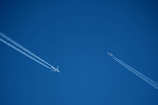 istock Two contrails. Airplane trail in the clear blue sky 2206859704