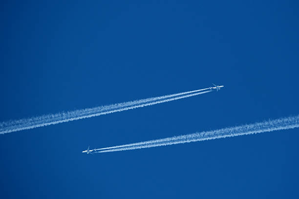 istock Two contrails. Airplane trail in the clear blue sky 2206859872