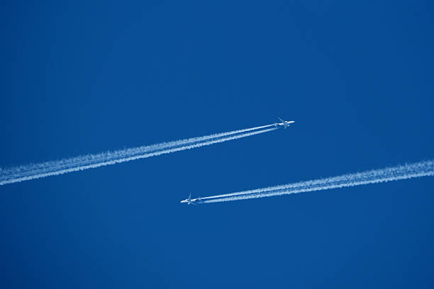 istock Two contrails. Airplane trail in the clear blue sky 2206859877
