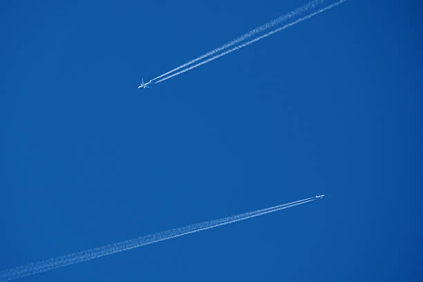 istock Two contrails. Airplane trail in the clear blue sky 2206860550