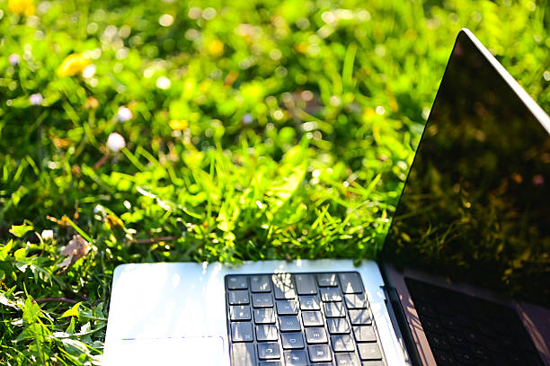 istock Laptop on green grass in bright sunlight 2206861786