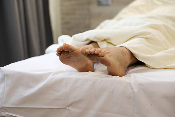 istock Restful Moments: Feet Relaxing on the Bedside 2206862042